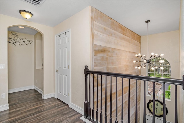 hall with a chandelier and dark hardwood / wood-style floors