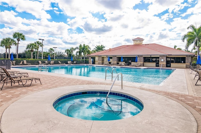 view of pool featuring a patio and a hot tub