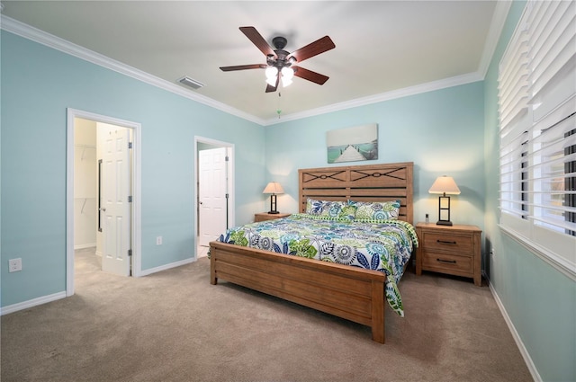 carpeted bedroom with ensuite bath, ceiling fan, and crown molding