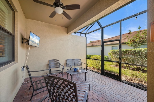 sunroom / solarium featuring ceiling fan