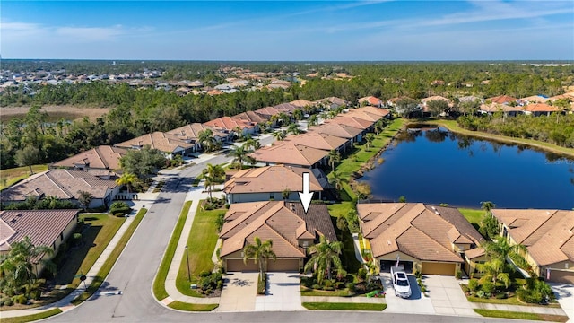 birds eye view of property featuring a water view and a residential view