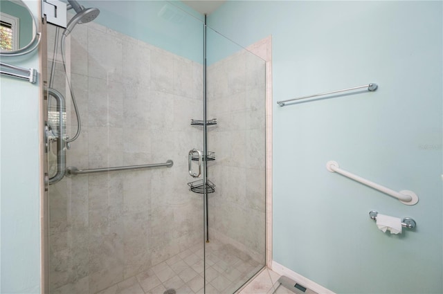 bathroom with a stall shower and baseboards