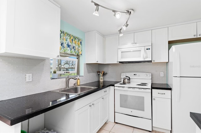 kitchen with tasteful backsplash, light tile patterned flooring, white cabinets, and white appliances