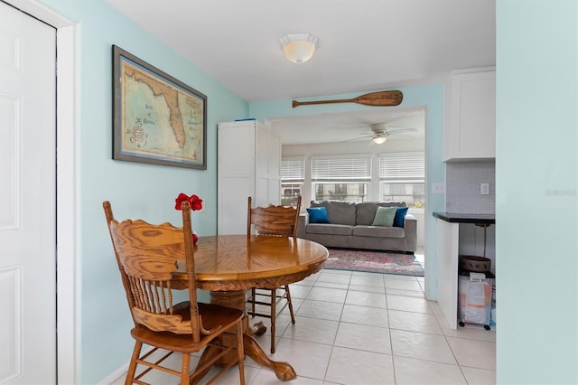 tiled dining room featuring ceiling fan