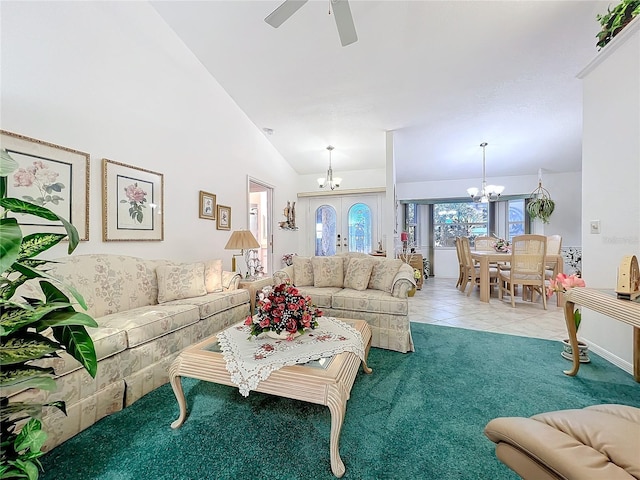 living room with tile patterned flooring, french doors, ceiling fan with notable chandelier, and high vaulted ceiling