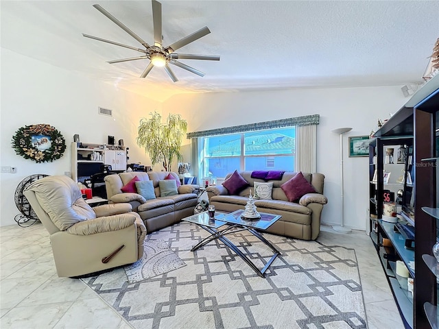 living room featuring a textured ceiling, ceiling fan, and lofted ceiling