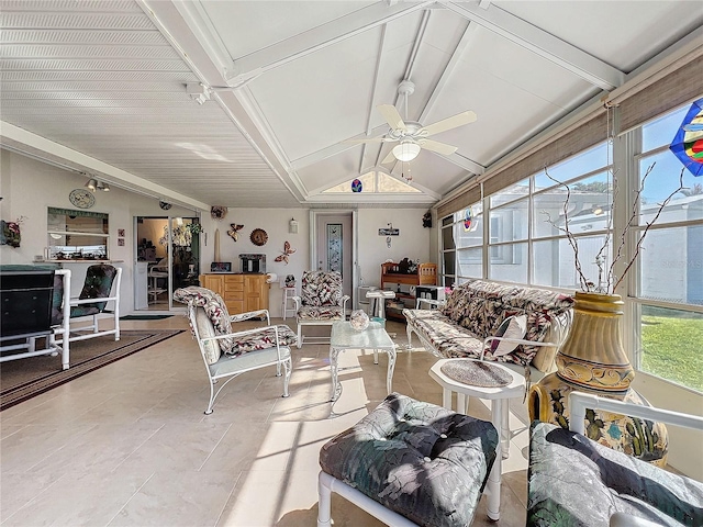 living room featuring vaulted ceiling with beams, ceiling fan, and a healthy amount of sunlight