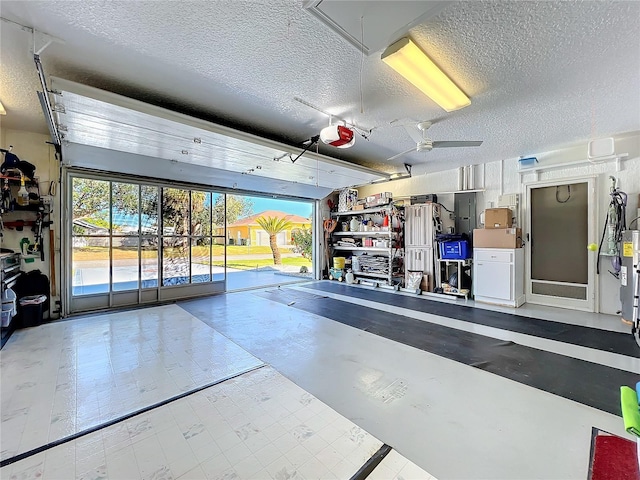 garage featuring ceiling fan and a garage door opener