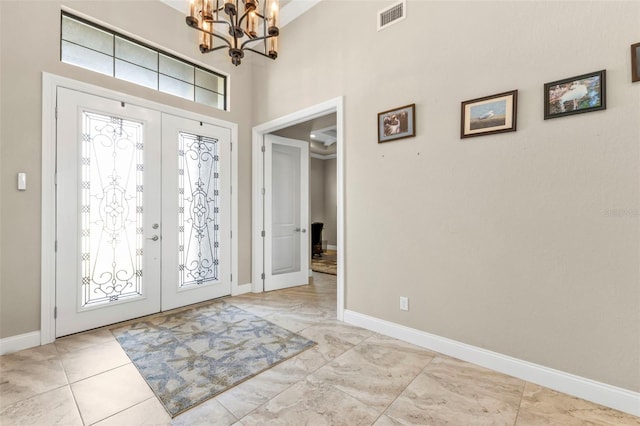 foyer with a chandelier and french doors