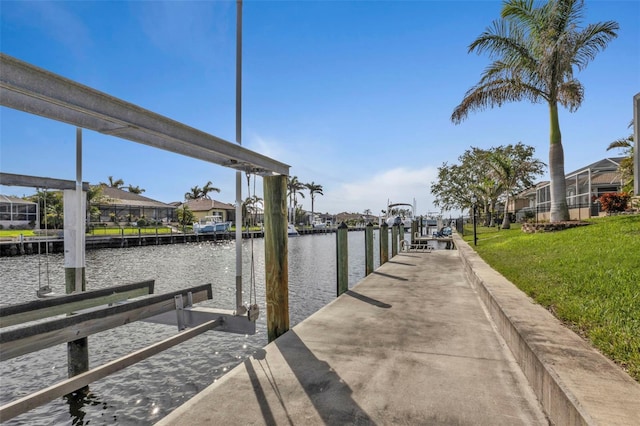 view of dock featuring a yard and a water view