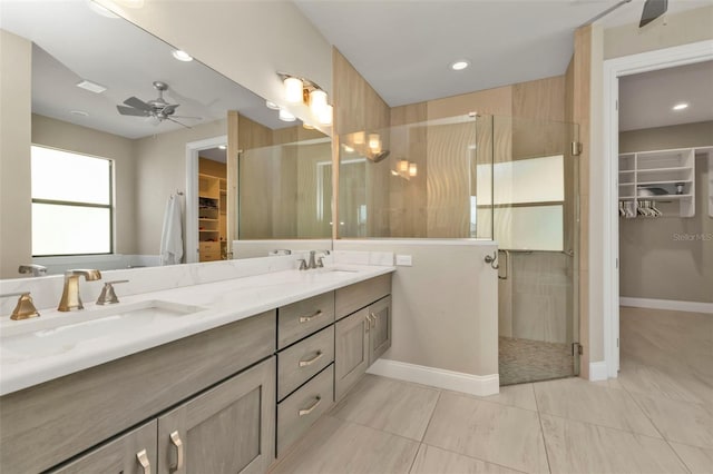 bathroom featuring ceiling fan, vanity, and a shower with shower door