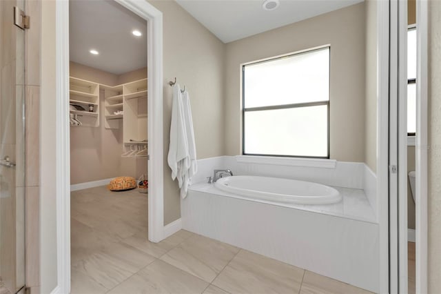 bathroom featuring a relaxing tiled tub