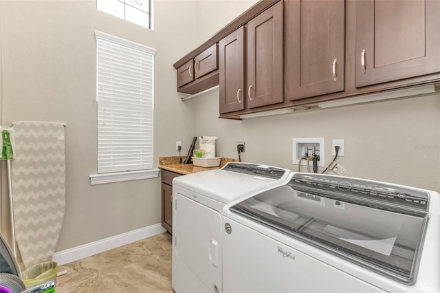 laundry area featuring cabinets, separate washer and dryer, and light tile patterned flooring