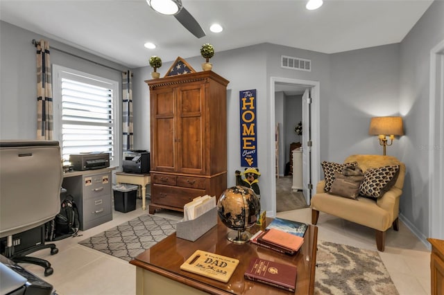 tiled home office featuring ceiling fan