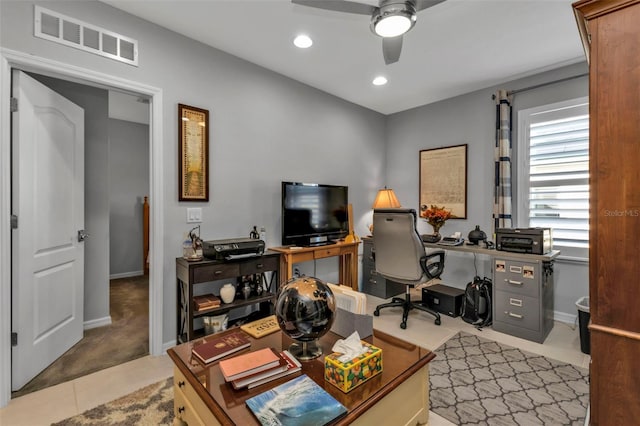 office space featuring light carpet and ceiling fan