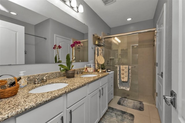 bathroom featuring vanity, tile patterned floors, and walk in shower