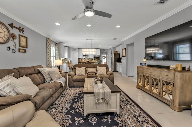 living room featuring light tile patterned flooring, ceiling fan with notable chandelier, and ornamental molding