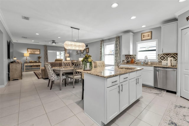 kitchen featuring white cabinetry, dishwasher, crown molding, pendant lighting, and a kitchen island with sink