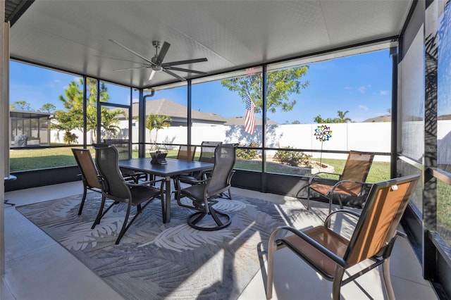 sunroom / solarium featuring ceiling fan