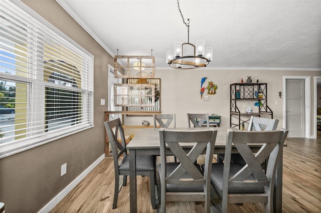 dining room featuring hardwood / wood-style floors, crown molding, and a chandelier