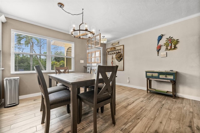 dining space featuring ornamental molding, light hardwood / wood-style floors, and a notable chandelier