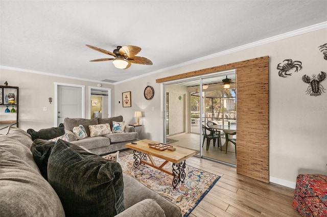 living room with crown molding, light hardwood / wood-style flooring, and ceiling fan