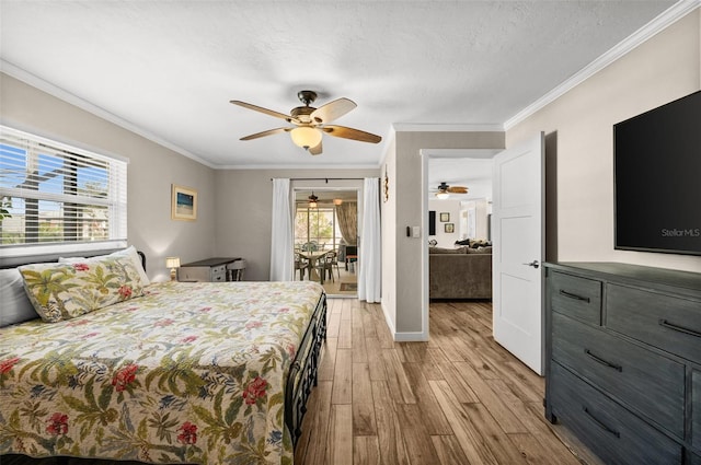 bedroom featuring a textured ceiling, light hardwood / wood-style floors, ceiling fan, and ornamental molding