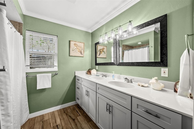 bathroom with hardwood / wood-style floors, vanity, and ornamental molding