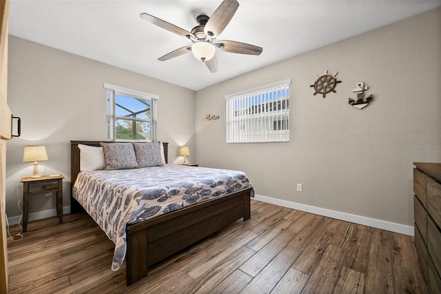 bedroom with ceiling fan and hardwood / wood-style flooring