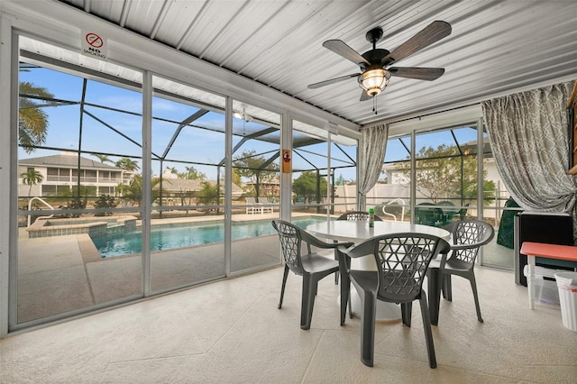 unfurnished sunroom with ceiling fan