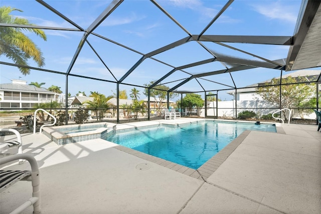 view of swimming pool with glass enclosure, an in ground hot tub, and a patio area