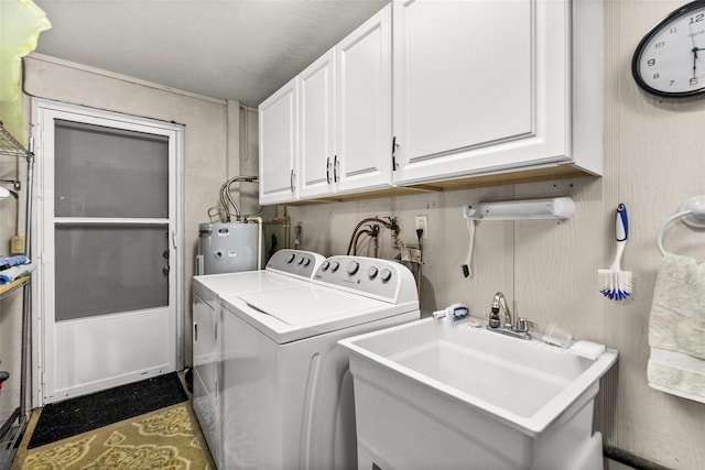 laundry area with electric water heater, cabinets, separate washer and dryer, and sink