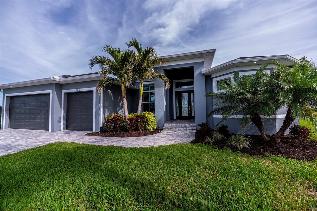 view of front facade with a front lawn and a garage