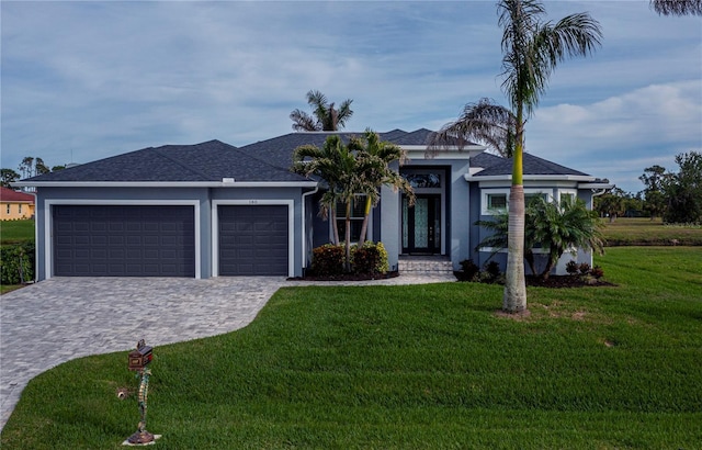 single story home featuring a front yard and a garage