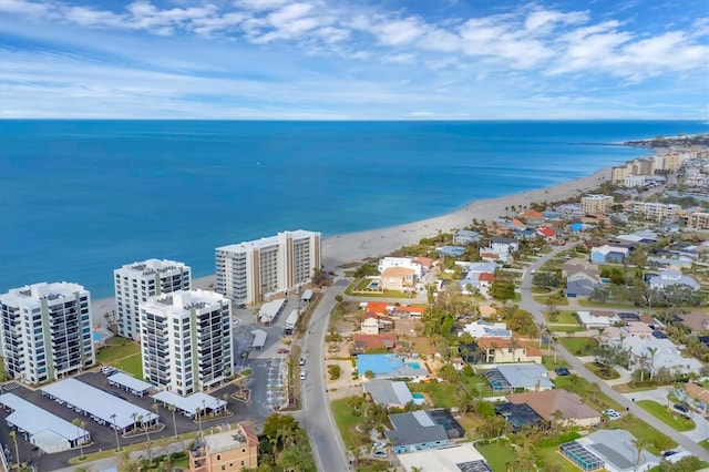 birds eye view of property featuring a water view and a beach view