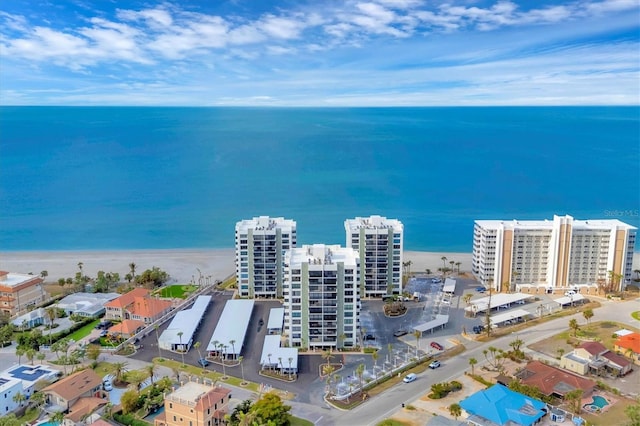 drone / aerial view featuring a water view and a view of the beach