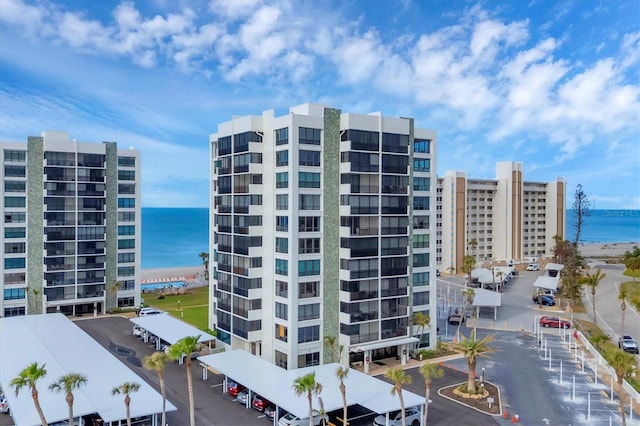 view of property with a view of the beach and a water view