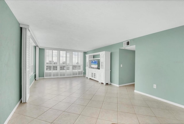 unfurnished living room with light tile patterned flooring