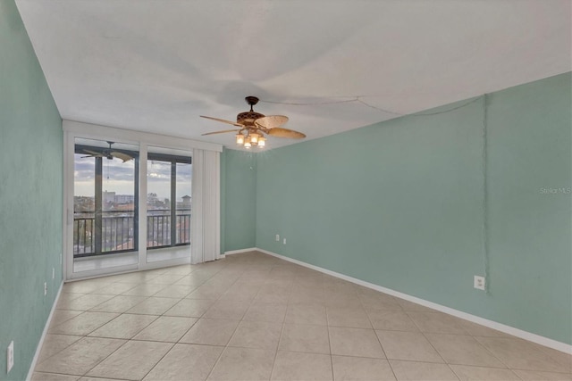 tiled spare room featuring ceiling fan