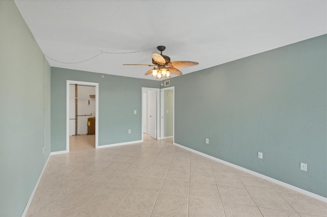 tiled empty room with ceiling fan