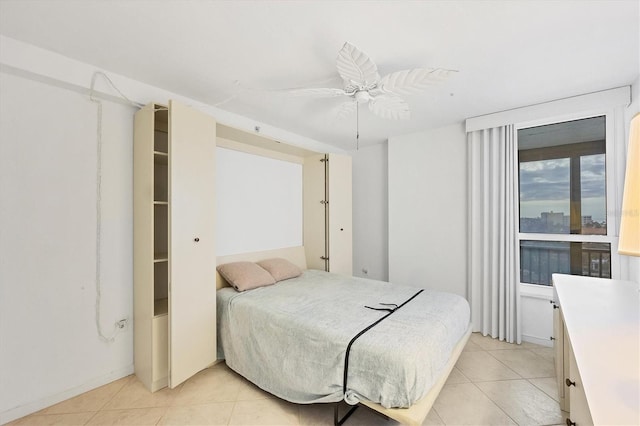 tiled bedroom featuring ceiling fan