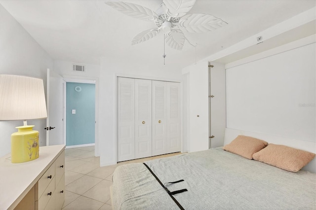 tiled bedroom with a closet