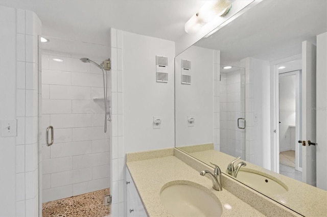 bathroom with vanity and a shower with shower door