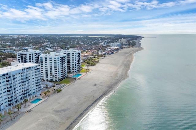 bird's eye view featuring a water view and a beach view