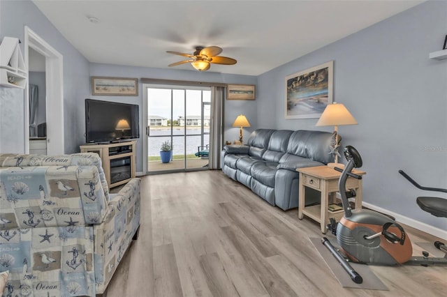 living room featuring ceiling fan and light wood-type flooring