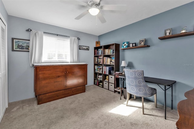 carpeted office featuring ceiling fan