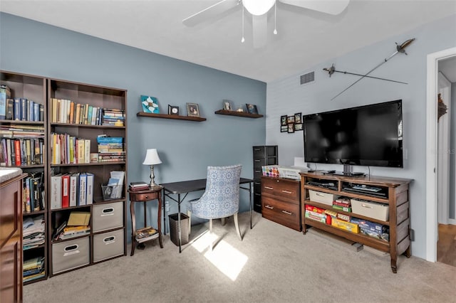 office space featuring light colored carpet and ceiling fan