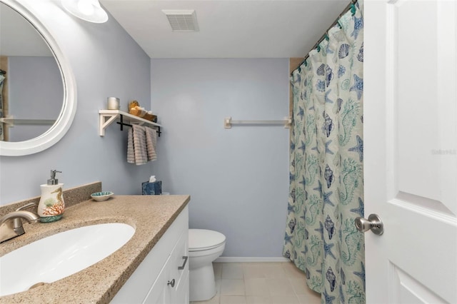 bathroom with tile patterned floors, vanity, toilet, and walk in shower