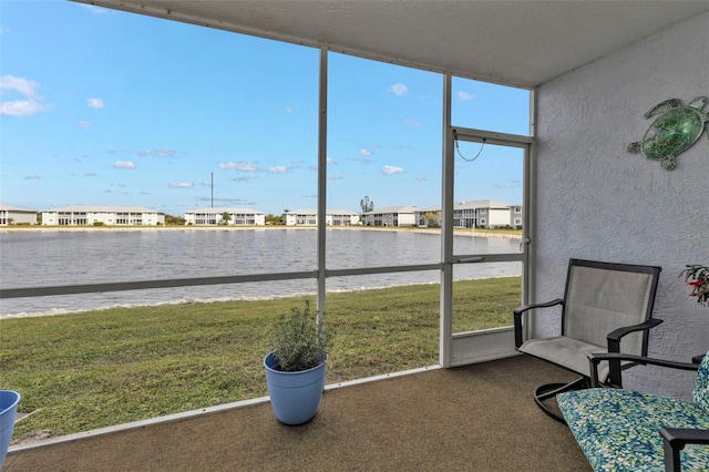 unfurnished sunroom featuring a water view