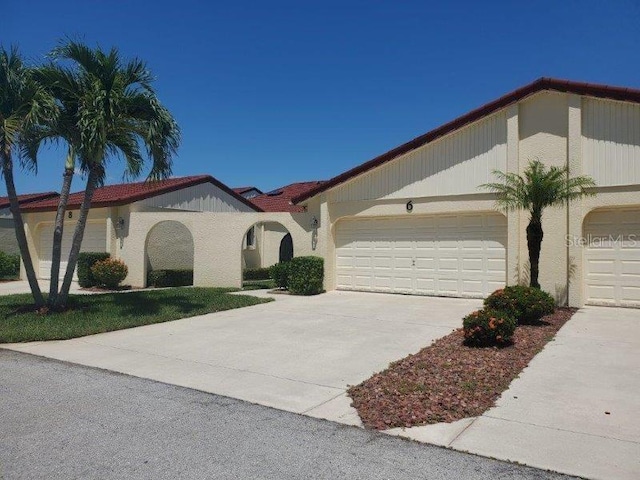 mediterranean / spanish home with a garage